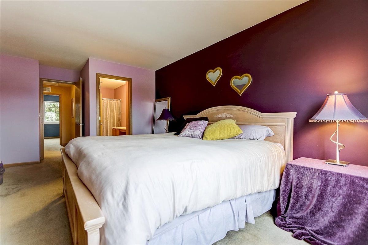63 Rolling Oaks Road, Unit B Sugar Grove, IL 60554 - Photo 14 of 23 a bedroom with a bed and a lamp