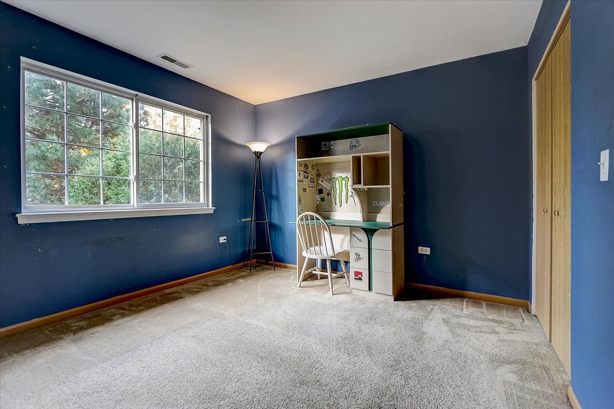 63 Rolling Oaks Road, Unit B Sugar Grove, IL 60554 - Photo 16 of 23 a view of an empty room with a window