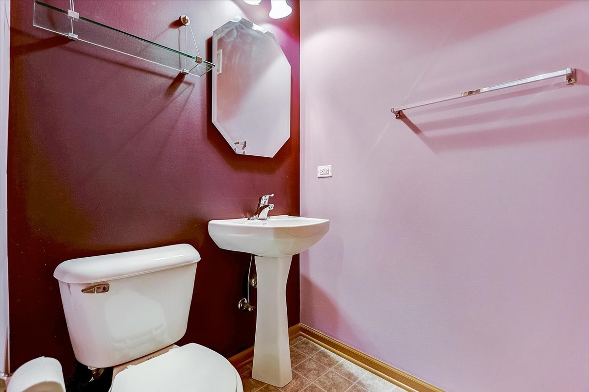 63 Rolling Oaks Road, Unit B Sugar Grove, IL 60554 - Photo 19 of 23 a bathroom with a toilet sink and mirror