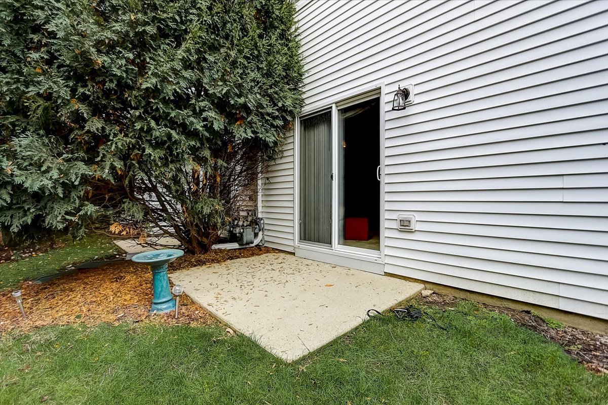 63 Rolling Oaks Road, Unit B Sugar Grove, IL 60554 - Photo 21 of 23 a view of a backyard with a large tree