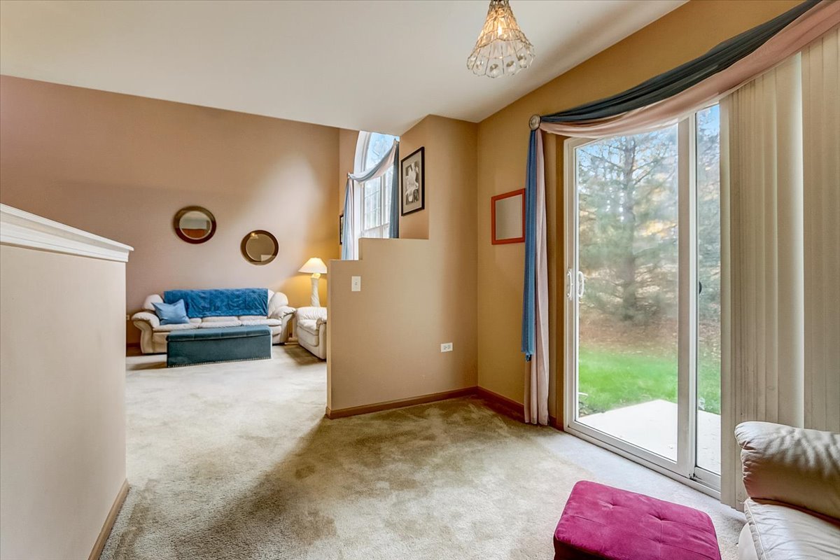 63 Rolling Oaks Road, Unit B Sugar Grove, IL 60554 - Photo 6 of 23 a bedroom with furniture and a large window