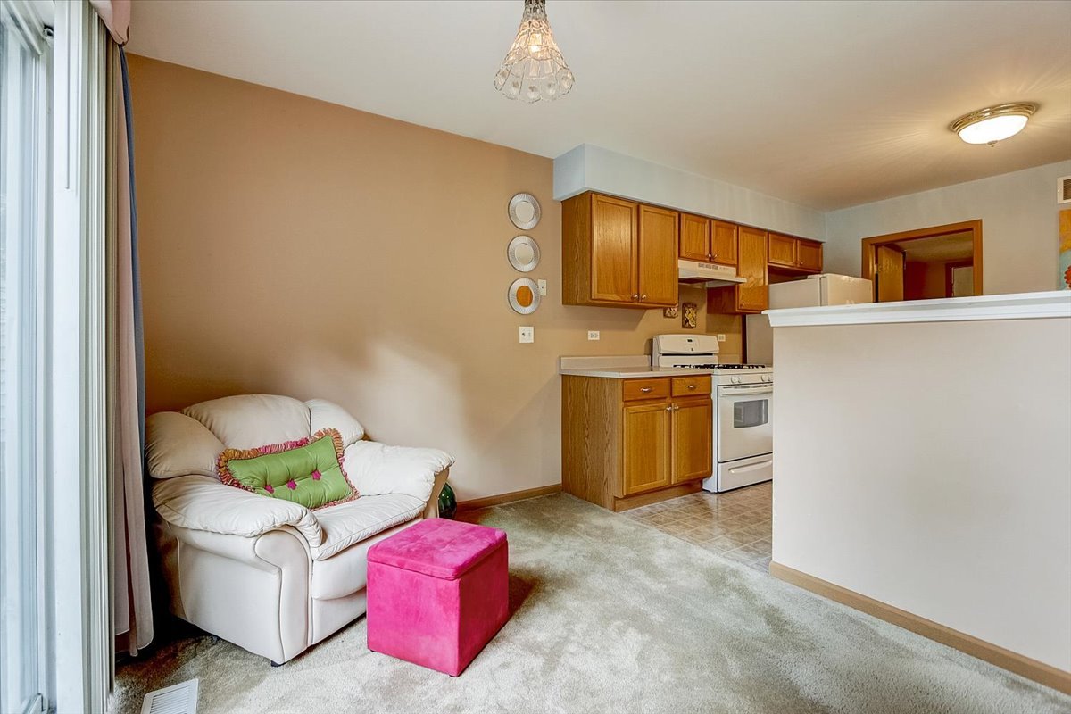 63 Rolling Oaks Road, Unit B Sugar Grove, IL 60554 - Photo 8 of 23 a living room with furniture and a table