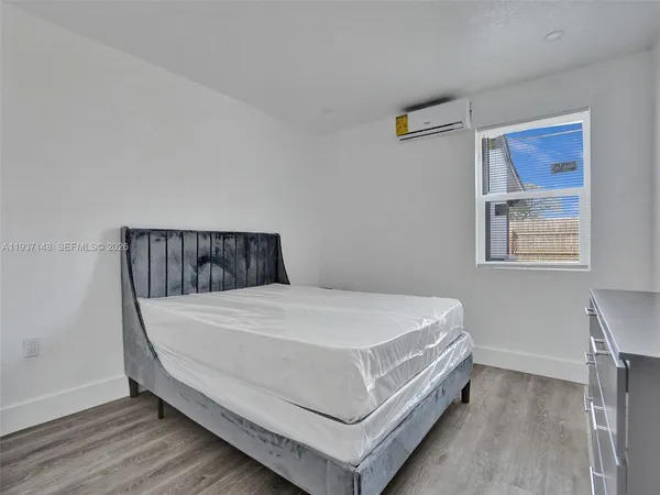 a bed sitting in a bedroom next to a window