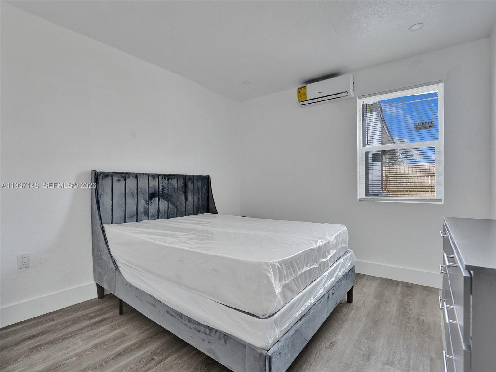 6143 Southwest 40th Street Miramar, FL 33023 - Photo 11 of 24 a bed sitting in a bedroom next to a window