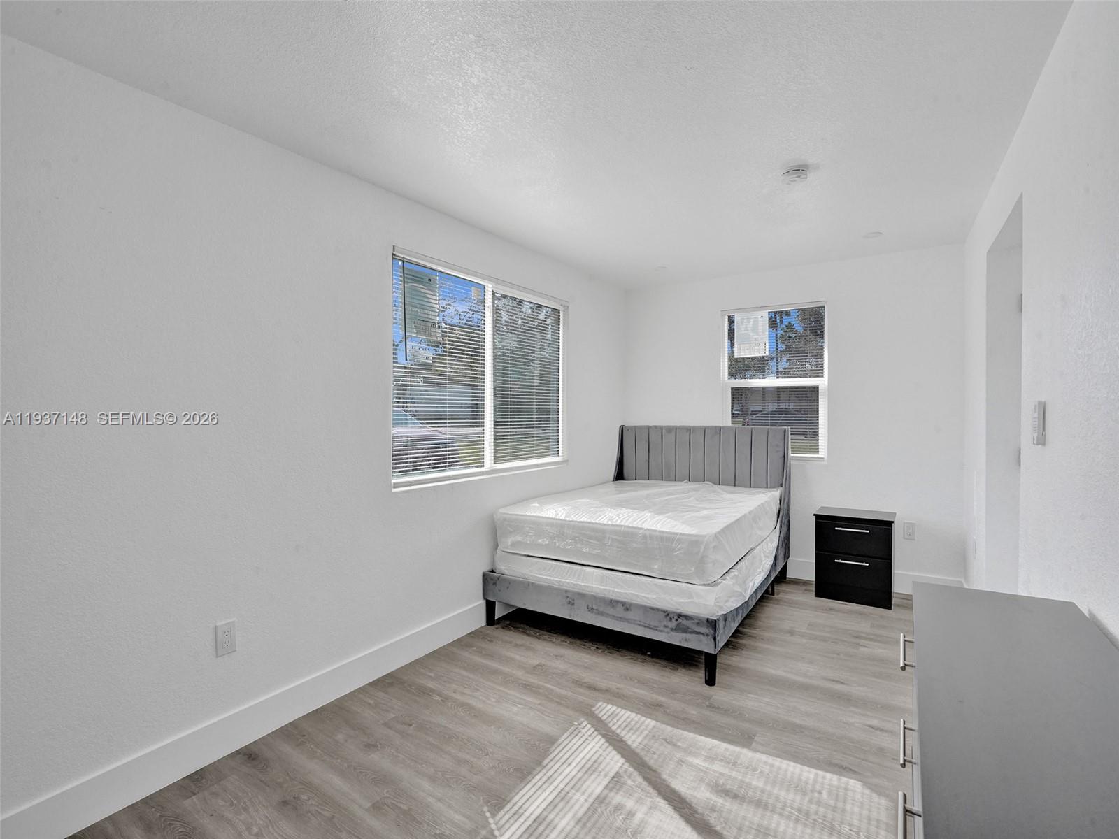 6143 Southwest 40th Street Miramar, FL 33023 - Photo 13 of 24 a bedroom with a bed and window