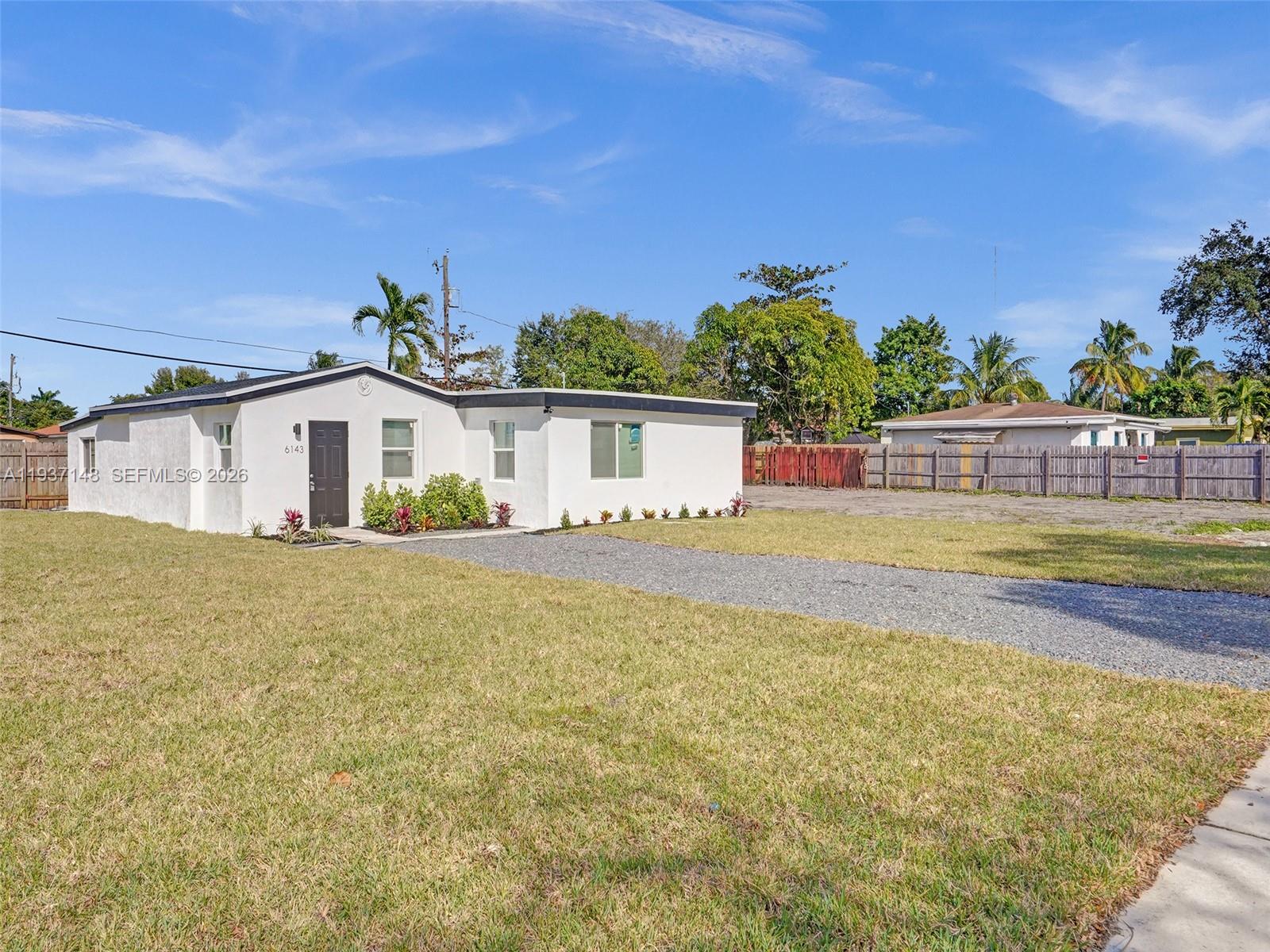 6143 Southwest 40th Street Miramar, FL 33023 - Photo 3 of 24 a front view of a house with a garden and plants