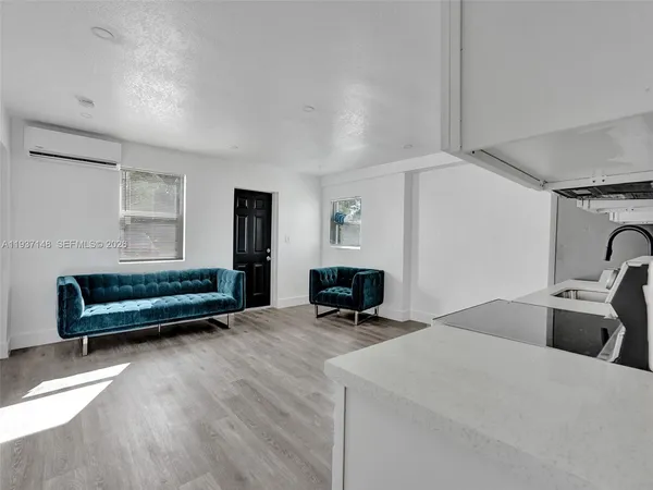 a living room with a couch and dresser