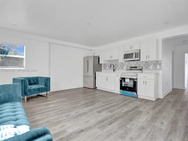 a view of kitchen with microwave and cabinets