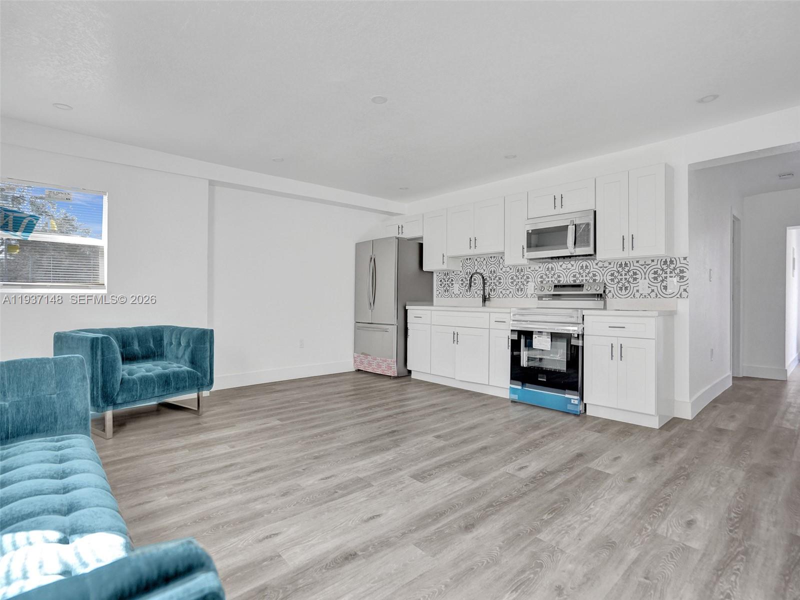 6143 Southwest 40th Street Miramar, FL 33023 - Photo 6 of 24 a view of kitchen with microwave and cabinets