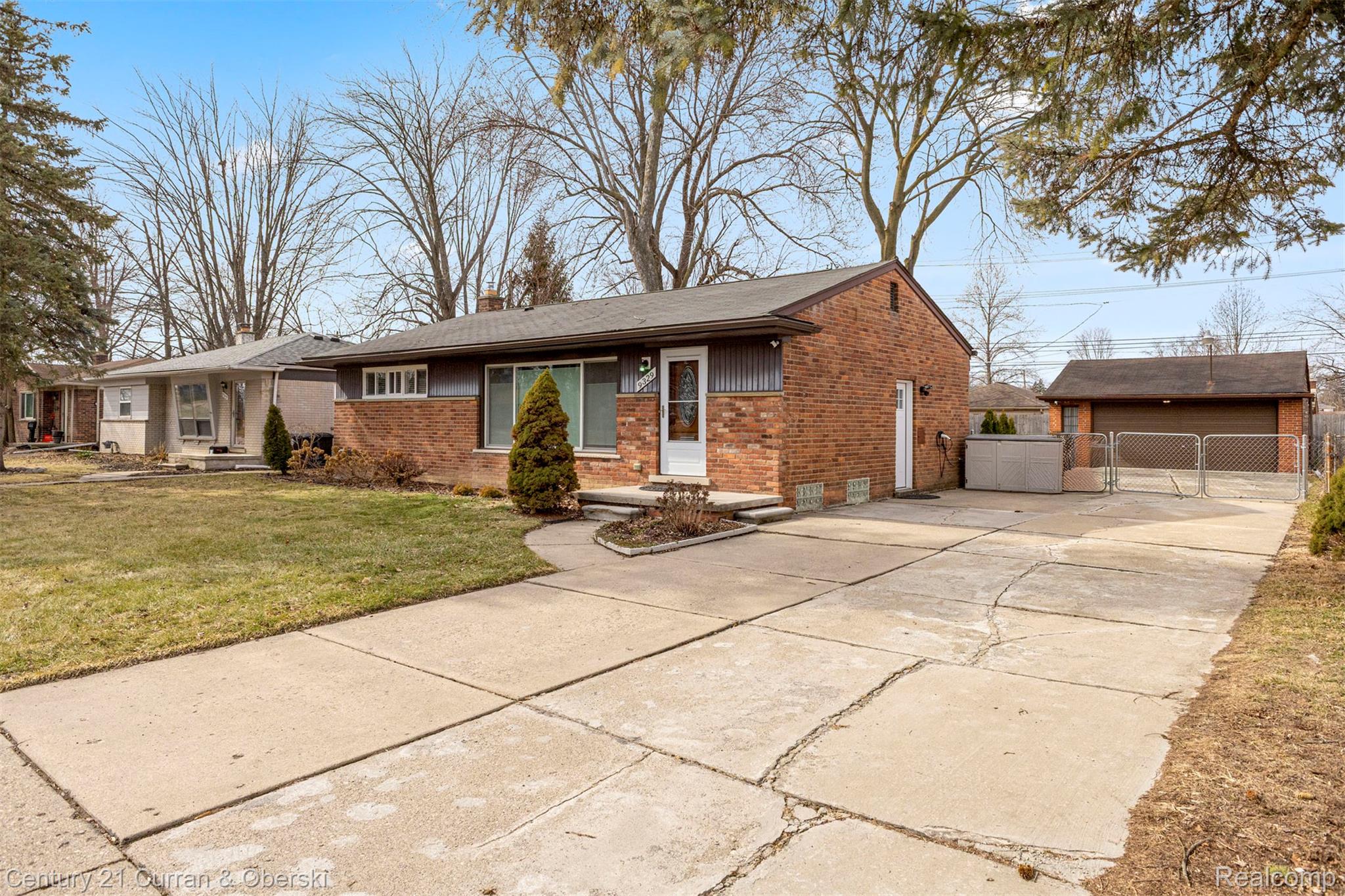 9329 Merriman Road Livonia, MI 48150 - Photo 2 of 32 Single story home featuring brick siding, an outbuilding, concrete driveway, and a chimney