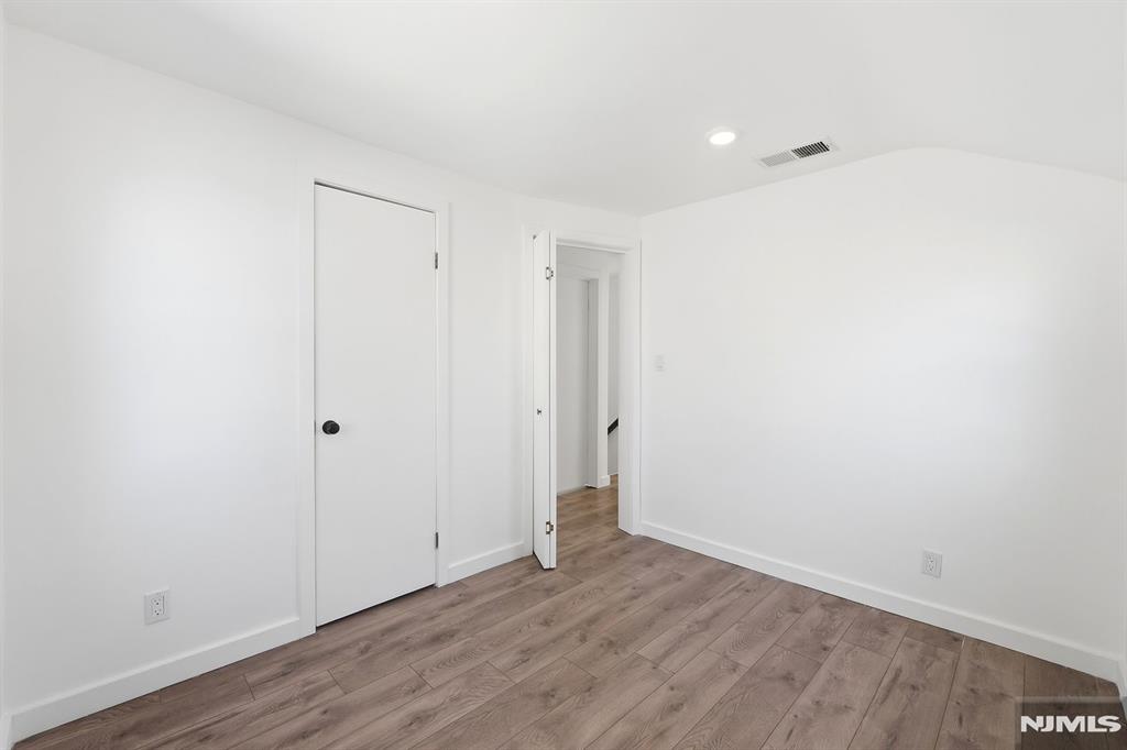 73 MacArthur Avenue Lodi, NJ 07644 - Photo 29 of 46 a view of an empty room with wooden floor