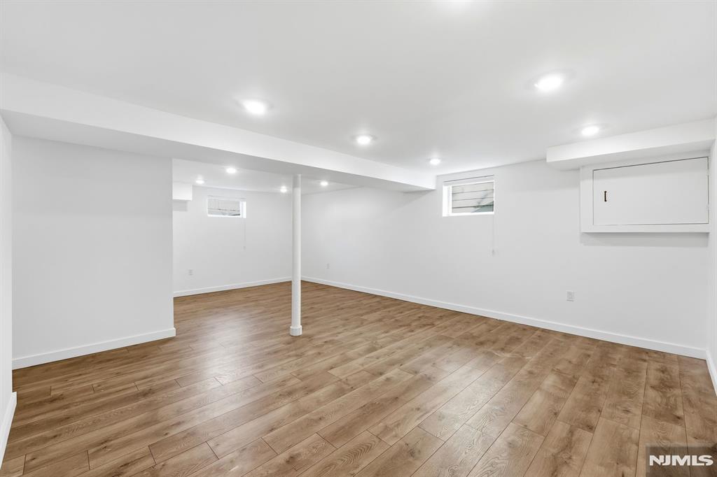 73 MacArthur Avenue Lodi, NJ 07644 - Photo 30 of 46 a view of an empty room with wooden floor