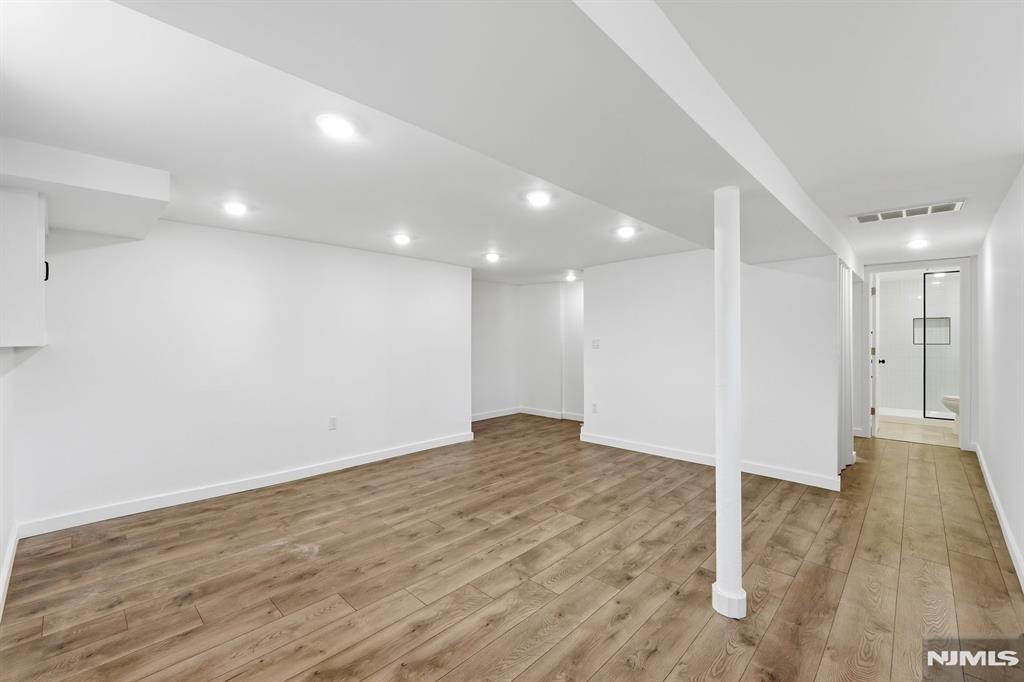 73 MacArthur Avenue Lodi, NJ 07644 - Photo 31 of 46 a view of an empty room with wooden floor