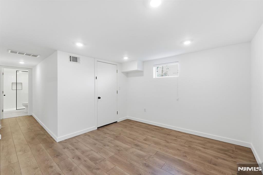 73 MacArthur Avenue Lodi, NJ 07644 - Photo 33 of 46 wooden floor in an empty room with a window