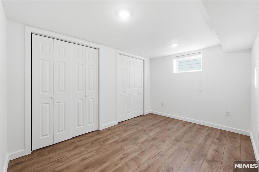 73 MacArthur Avenue Lodi, NJ 07644 - Photo 39 of 46 a view of an empty room with wooden floor