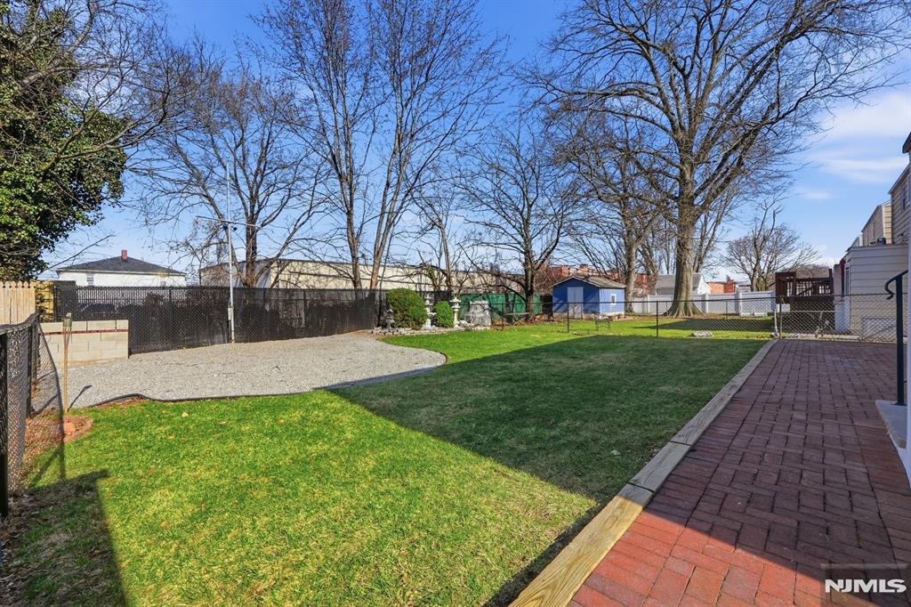 73 MacArthur Avenue Lodi, NJ 07644 - Photo 44 of 46 a view of a backyard with large trees