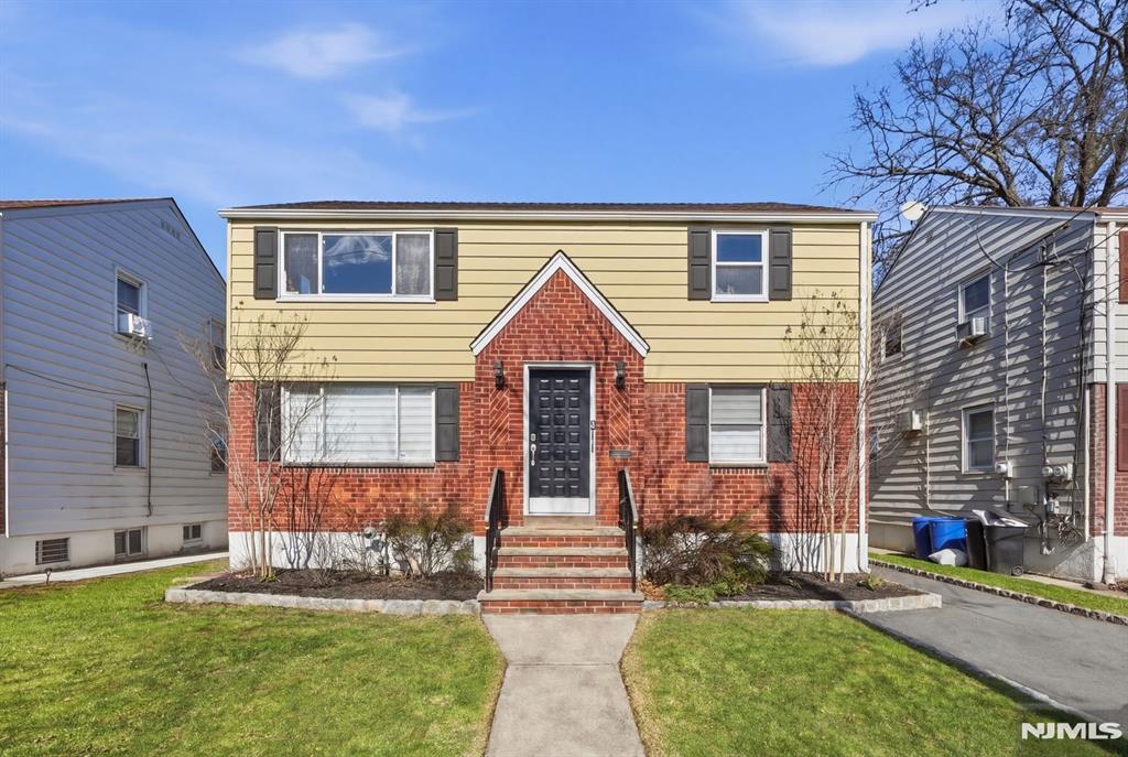 73 MacArthur Avenue Lodi, NJ 07644 - Photo 46 of 46 a front view of a house with a yard