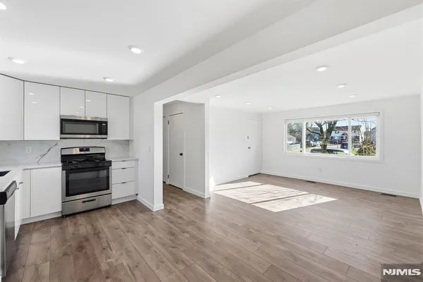 a view of a living room with furniture and wooden floor
