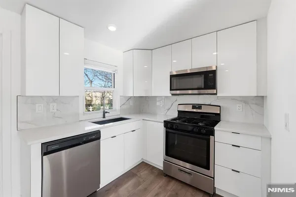 a view of kitchen with cabinets and wooden floor