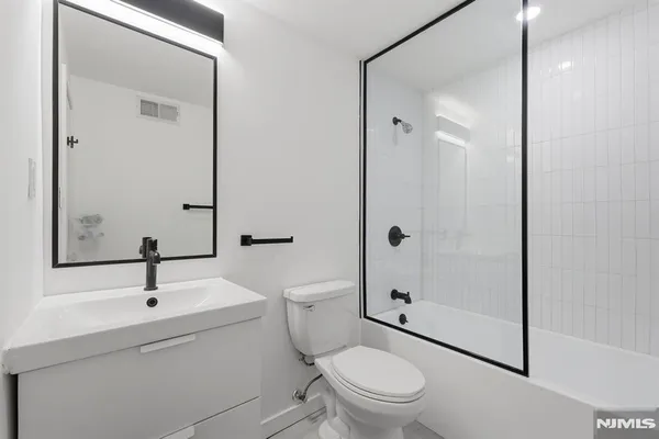 a view of a kitchen with a sink hardwood floor and a large window
