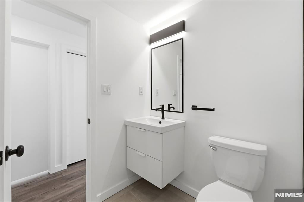 73 MacArthur Avenue Lodi, NJ 07644 - Photo 9 of 46 a bathroom with a toilet a sink and mirror