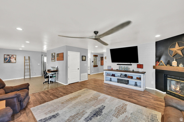 Wood-finish flooring, recessed lighting, and ceiling fan
