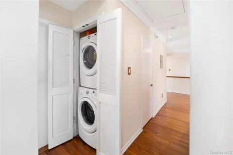 an empty room with a ceiling fan and window