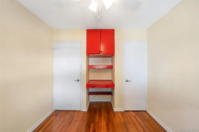 a view of a room with wooden floor