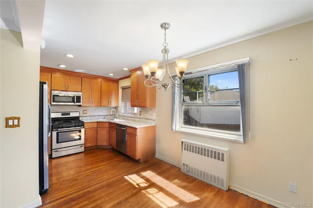 a kitchen with granite countertop a stove a sink and a refrigerator