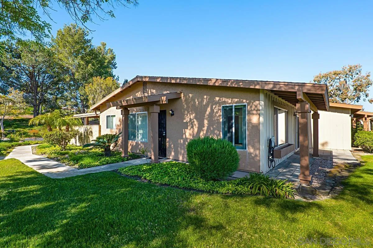 a front view of a house with a yard table and chairs