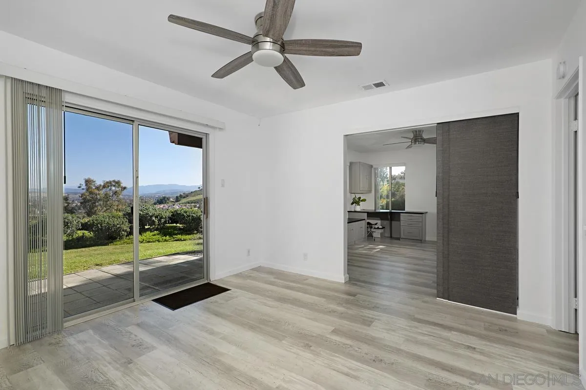 4523 Kittiwake Way Oceanside, CA 92057 - Photo 11 of 34 a view of a room with wooden floor garden view and a ceiling fan
