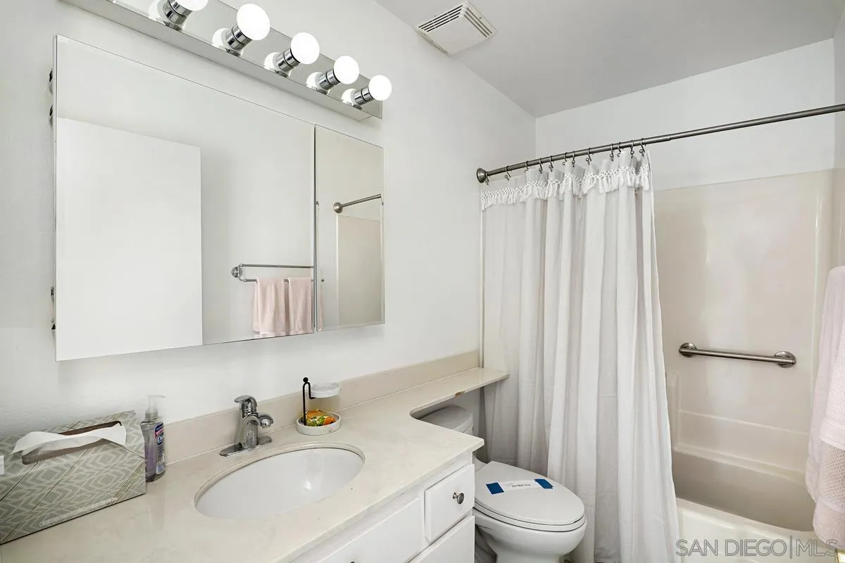 4523 Kittiwake Way Oceanside, CA 92057 - Photo 13 of 34 a bathroom with a sink a toilet and shower
