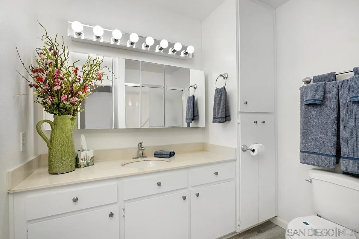 4523 Kittiwake Way Oceanside, CA 92057 - Photo 14 of 34 a bathroom with a sink vanity granite and a mirror
