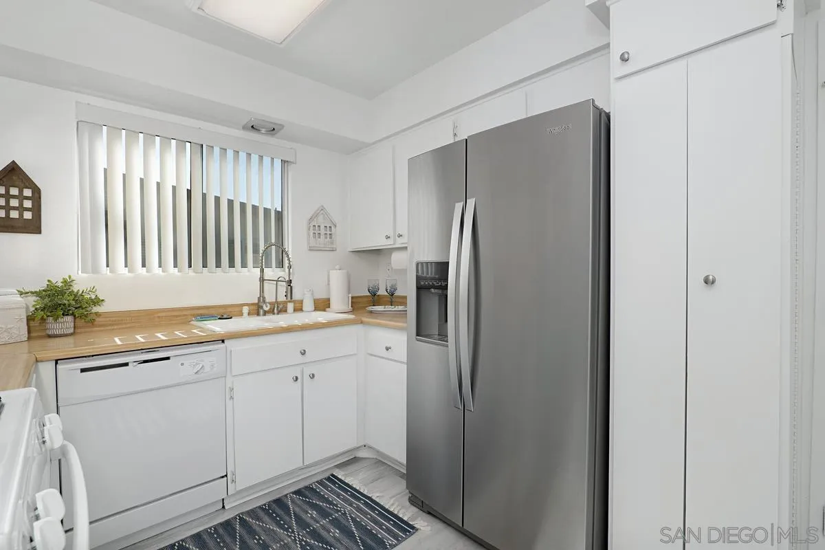 4523 Kittiwake Way Oceanside, CA 92057 - Photo 9 of 34 a kitchen with a refrigerator sink and cabinets