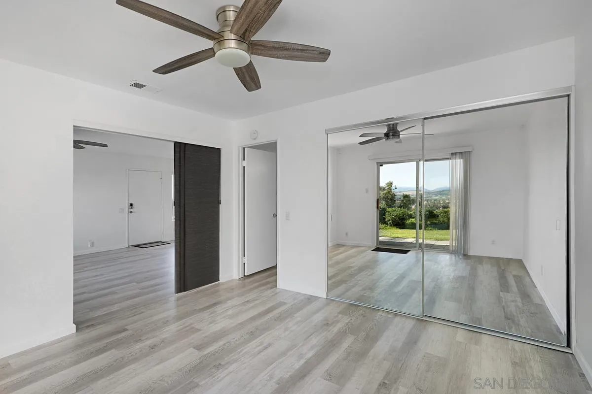 4523 Kittiwake Way Oceanside, CA 92057 - Photo 10 of 34 a view of an empty room with a window and wooden floor