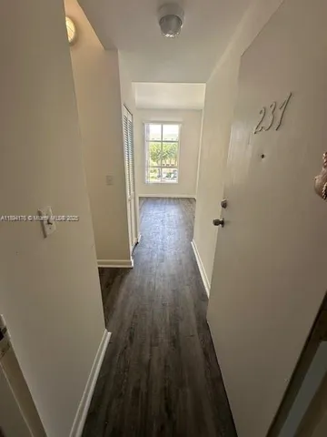wooden floor in a gallery next to a window