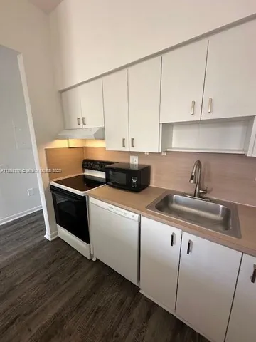a kitchen with a sink and cabinets