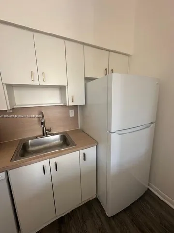 a white refrigerator freezer sitting inside of a kitchen