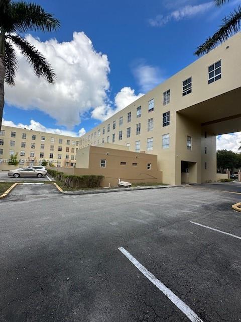 7420 West 20th Avenue, Unit 237 Hialeah, FL 33016 - Photo 2 of 34 a large building with a large parking space