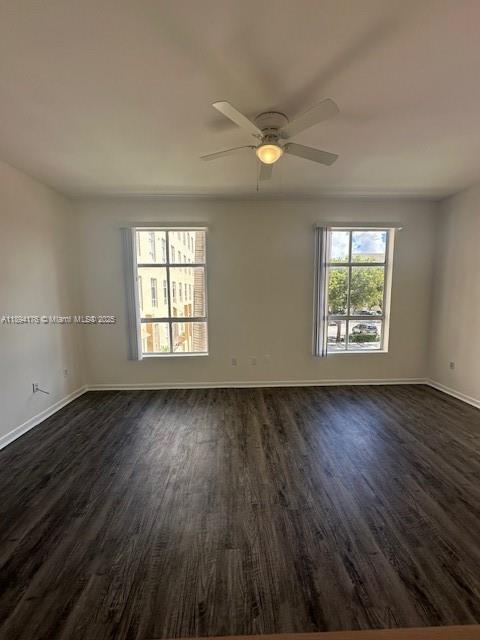 7420 West 20th Avenue, Unit 237 Hialeah, FL 33016 - Photo 21 of 34 an empty room with wooden floor and windows