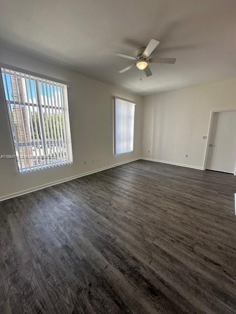 7420 West 20th Avenue, Unit 237 Hialeah, FL 33016 - Photo 23 of 34 an empty room with wooden floor fan and windows