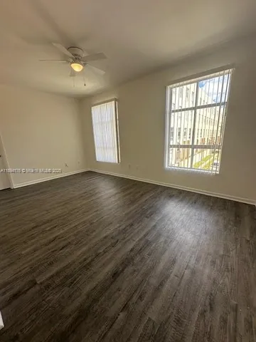 a view of a kitchen with wooden floor and a sink