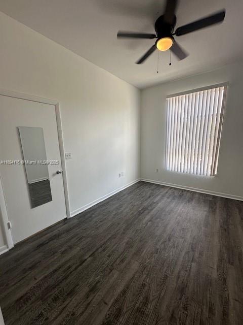 7420 West 20th Avenue, Unit 237 Hialeah, FL 33016 - Photo 30 of 34 an empty room with wooden floor and windows