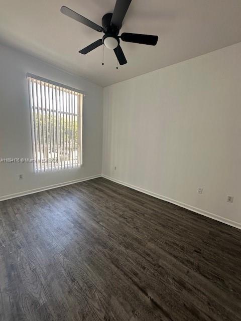 7420 West 20th Avenue, Unit 237 Hialeah, FL 33016 - Photo 31 of 34 a view of an empty room with wooden floor and a window
