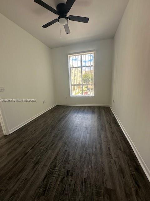 7420 West 20th Avenue, Unit 237 Hialeah, FL 33016 - Photo 32 of 34 an empty room with wooden floor and windows
