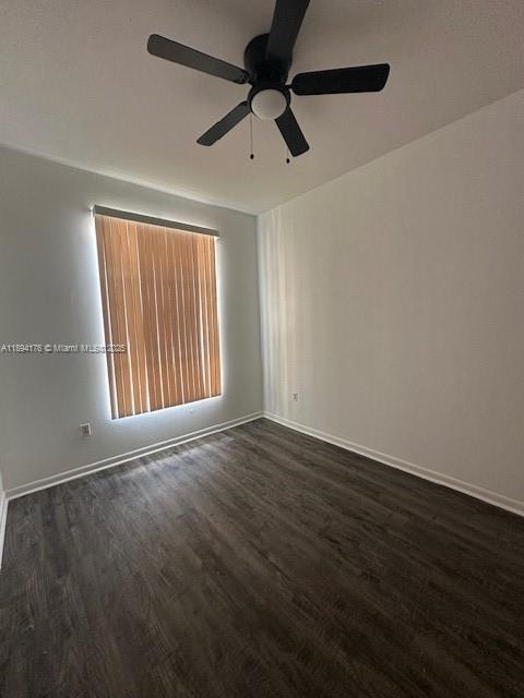7420 West 20th Avenue, Unit 237 Hialeah, FL 33016 - Photo 33 of 34 an empty room with wooden floor fan and windows