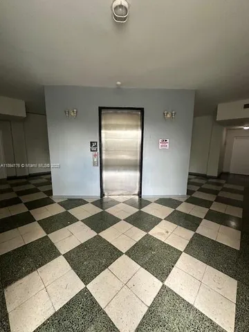 a bathroom with a black and white checkered floor