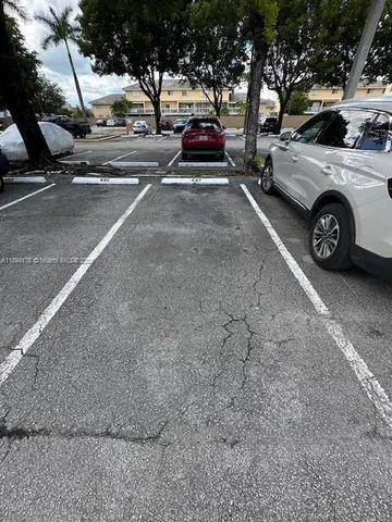 a view of cars parked on the side of a street