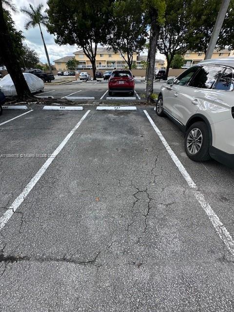 7420 West 20th Avenue, Unit 237 Hialeah, FL 33016 - Photo 9 of 34 a view of cars parked on the side of a street