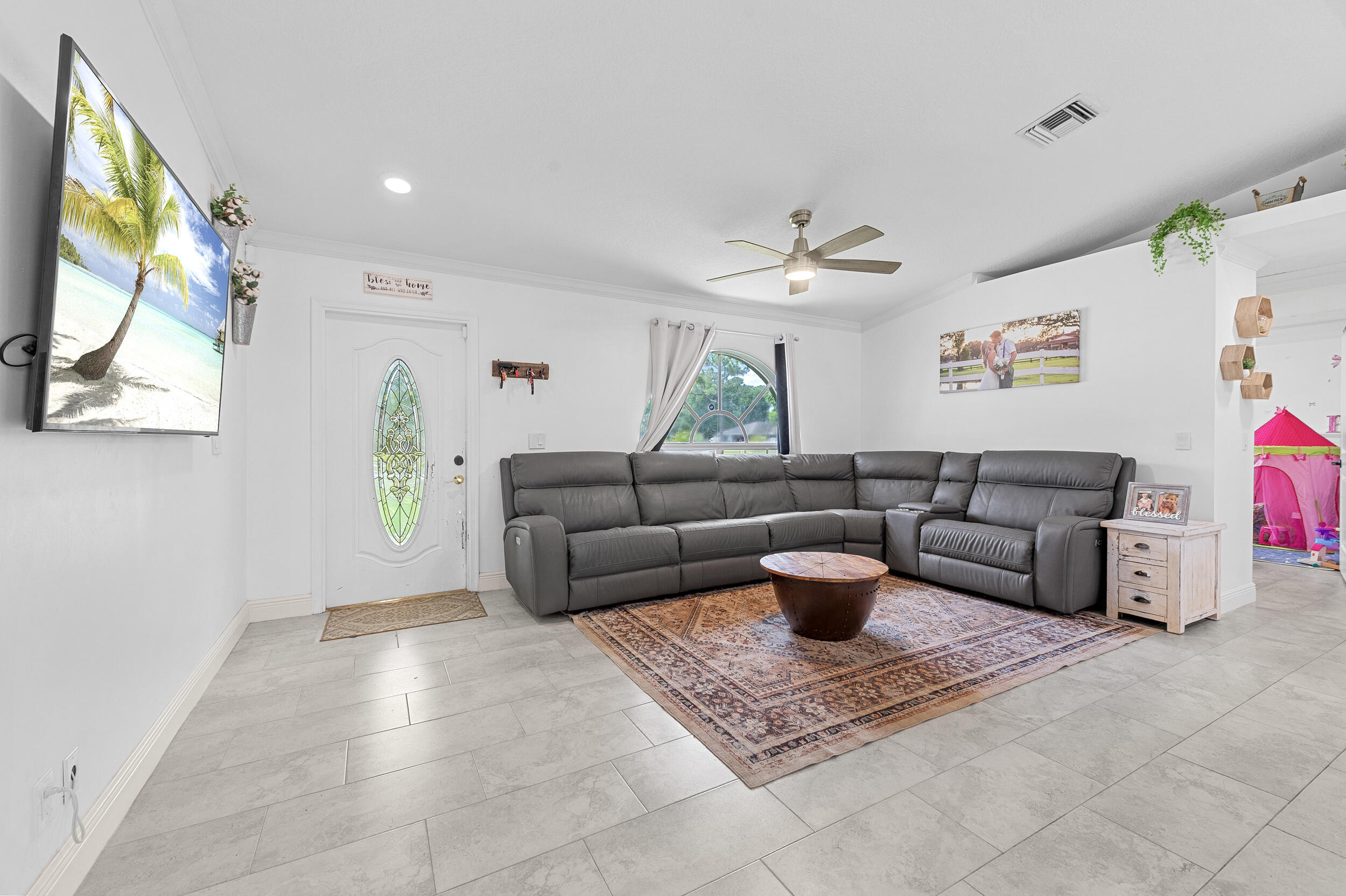 18389 41st Road North The Acreage, FL 33470 - Photo 16 of 44 a living room with furniture and a chandelier